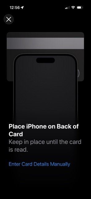 A screen instructing the user to place the iPhone on the back of the card, with an Enter Card Details Manually link below.